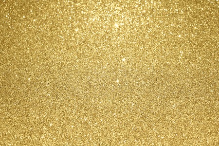 Gold glitter particles textured backgroundの写真素材
