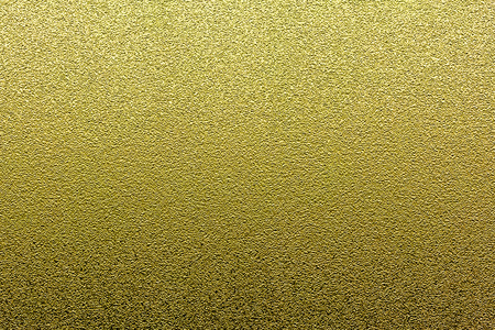 Gold glitter background. Golden grunge grain texture.の写真素材
