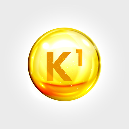 Vitamin K1 gold icon. Phylloquinone vitamin drop pill capsule. Shining golden essence droplet. Beauty treatment nutrition skin care design. Vector illustrationのイラスト素材