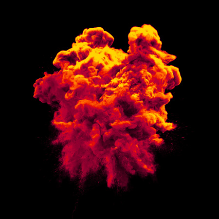 Paint powder explosion or abstract color splash of red yellow particles burst isolated on black background. Abstract color glitter explode with glowing shimmer texture effect for cosmetic backgroundの写真素材