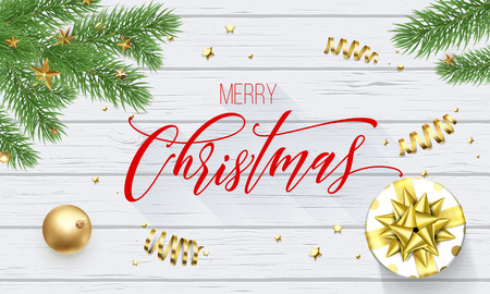 Merry Christmas holiday golden decoration and calligraphy font for greeting card on white wooden background. Vector Christmas or New Year golden shiny gift ribbon for Xmas decoration designのイラスト素材