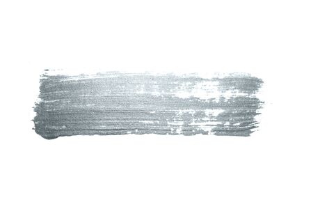 Silver paint brush stroke or abstract dab smear with silver glitter smudge texture on white background. Isolated glittering and sparkling silver paint or ink paintbrush splash stain for luxury designの写真素材