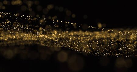 Light glitter wave, golden dust splash and glittering particles glow flow. Gold bokeh light overlay on black backgroundの写真素材
