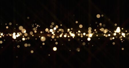 Gold light bokeh sparks, golden glitter shine. Shiny bright snow bokeh blur effect, shimmering dust light and magic glow sparkles, Christmas luxury backgroundの写真素材