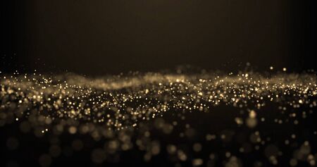 Gold glitter, shimmer particles magic golden glittering wave with sparkling dust light.の写真素材