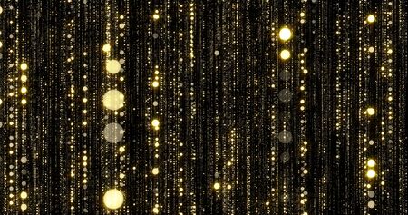 Golden glitter flowing particles threads with bokeh light sparks. Gold glitter falling curtain background with magic glowing shimmer glaresの写真素材