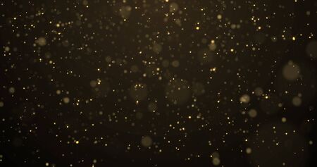 Golden glitter rain, gold particles glow with falling snow bokeh light effect.の写真素材
