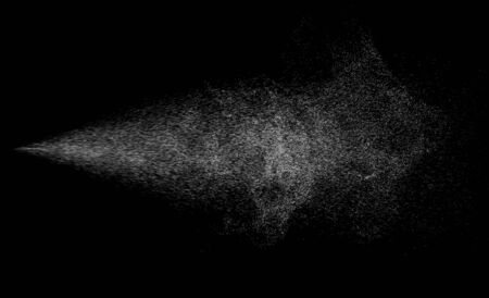 Spraying mist of air gun or atomizer and pulverize spray jet for cosmetic concept isolated on blackの写真素材