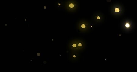 Bokeh light gold shine background with abstract blur flare effects. Golden yellow glitter particle flares with bright glowing shiny light bokeh sparkles on black backgroundの写真素材