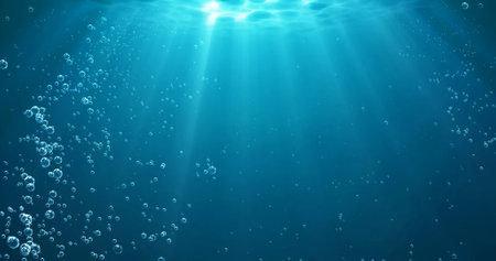 Underwater background with water bubbles and undersea light rays shineの写真素材