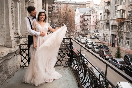 The bride and groom embrace on the balcony.の写真素材