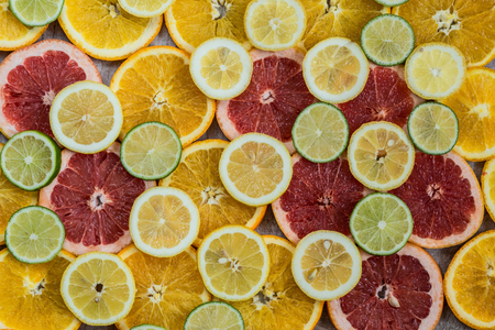 Citrus fruit background with sliced oranges lemons lime and grapefruitの写真素材