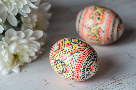 Easter Background with easter eggs and spring flowers on light wooden background.の写真素材