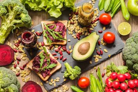 Healthy vegan food. Fresh vegetables on wooden background. Detox diet. Different colorful fresh juices.の写真素材