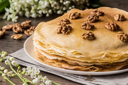 Delicious pancakes on wooden table with walnuts.の写真素材