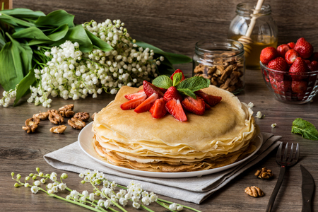 delicious pancakes on wooden table with fruitsの写真素材