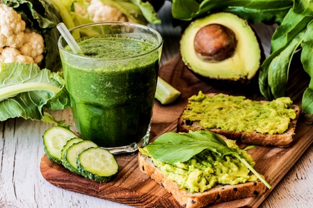 green smoothie and two sandwiches with avocado. healthy vegan foodの写真素材