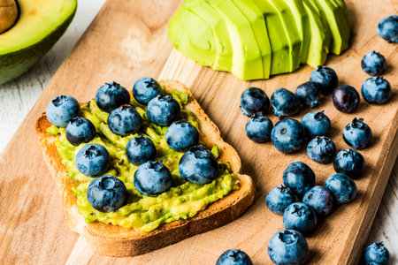 sandwich with avocado and blueberry. healthy vegetarian food