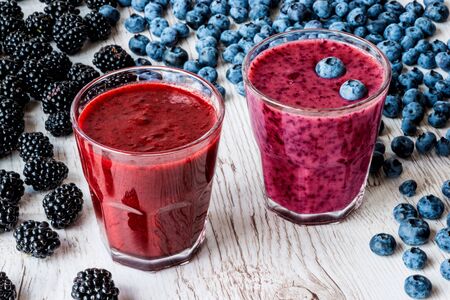 healthy drinks. smoothies with blackberry and blueberry with ingredients on white wooden backgroundの写真素材