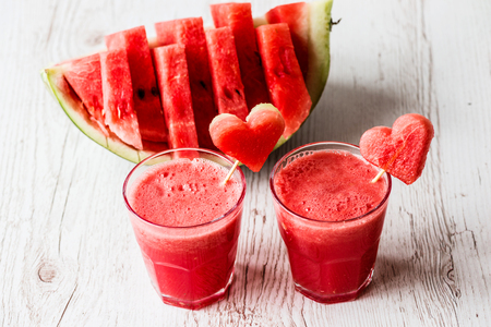 healthy drinks. watermelon smoothie with a hearts on white wooden backgroundの写真素材