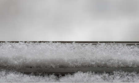 the snow falls on the windowsill. Close-upの写真素材