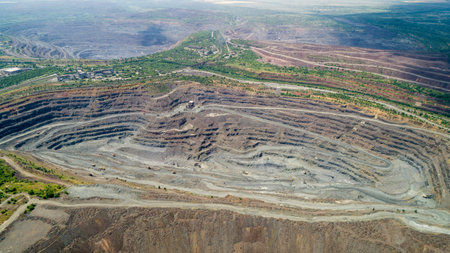 Aerial view of opencast mining quarry with lots of machinery at work.