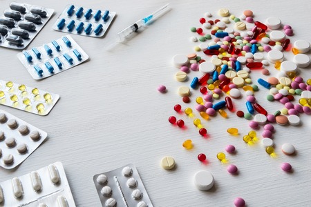 Blisters and colorful pills on a white background.の写真素材