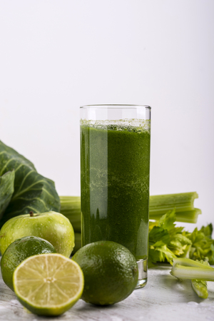 Healthy green smoothie with straw in a jar mug on white background. Copy space.の写真素材