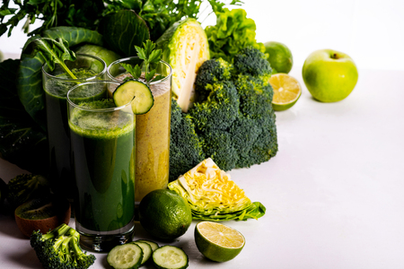 Vegan food and drinks with spinach, kiwi and cucumber on the white wooden background. Raw drinks and foods.の写真素材