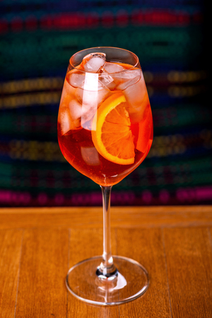 Aperol spritz cocktail in glass on wooden table in the interior of the restaurant.の写真素材