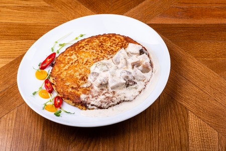 Potato pancakes in white mushroom sauce. Draniki - potato fritters. potato pancakes. The naitonal dish of Belarus, Ukraine and Russiaの写真素材
