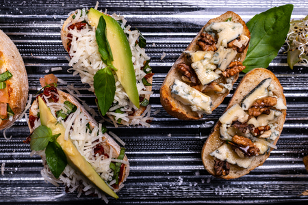 Delicious Italian antipasti bruschetta on black background. Close-up.の写真素材