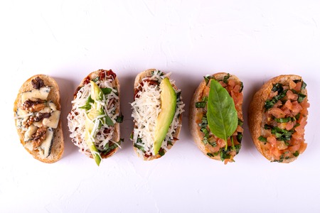 Delicious Italian antipasti bruschetta on white background. Macro. Copy space. Top view.の写真素材