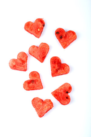 Sliced watermelon in the form of hearts on a white background. Top view.の写真素材