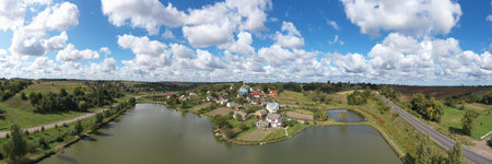Aerial View of a Beautiful Village Landscape on a Hill Near the Lake. In the center of the village...