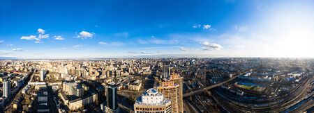 Panorama of Kyiv city at sunrise in dawn, panoramic view to the colorful winter cityscape in the morning. Railway station. Construction site.の写真素材