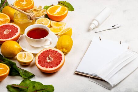 Notebook with place for text, things to protect against the virus and diseases and food for immunity boosting. Close-upの写真素材