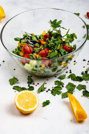 Healthy diet food. Fitness salad from different fresh greens , tomatoes, peppers, avocados, cucumbers with olive oil and balsamic sauce.の写真素材