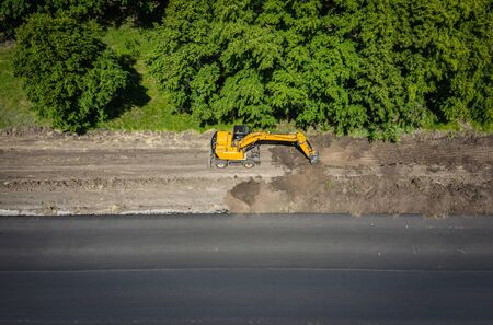 Road works. Excavator repair the road.の写真素材