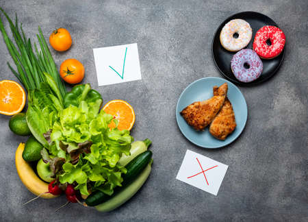 Choice between junk food and diet healthy vegan food. Top view.の写真素材