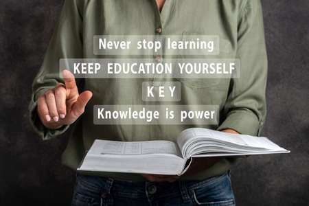 Keep educating yourself. Woman are clicking virtual screen.の写真素材