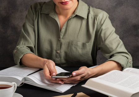 Girl looking at smartphone and studying. Education conceptの写真素材