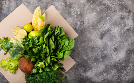 Different organic fresh vegetables in box. Order and delivery food concept top view.