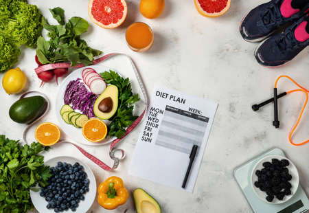 Healthy lifestyle concept. Weight loss program Fitness equipment Fresh food. Top view.の写真素材