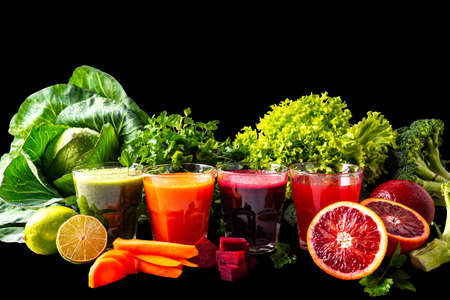 Vegan drinks with fruits and vegetables on the black isolated backgroundの写真素材