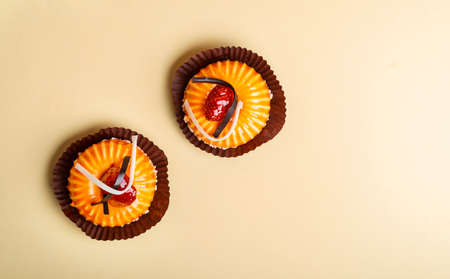 Orange mousse cakes on cream background top viewの写真素材