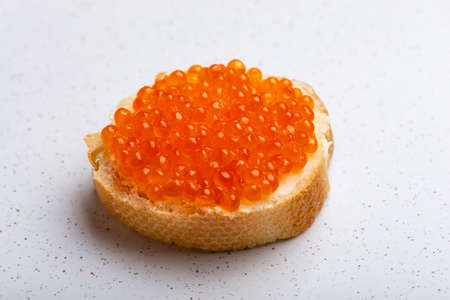 Sandwich with red caviar on whithe backgroundの写真素材
