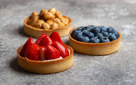 Assorted tarts with custard and fillingの写真素材
