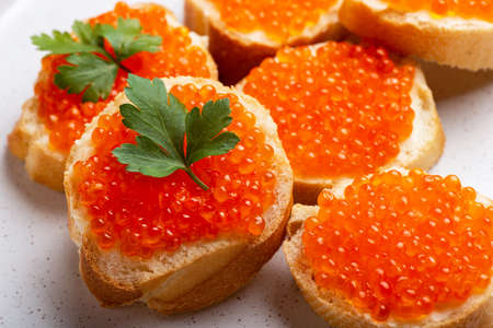 Close-up of sandwiches with salmon caviar toppingsの写真素材