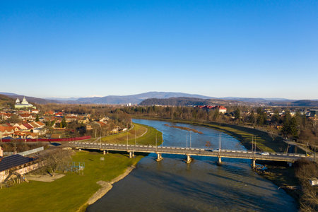 The Mukachevo city center at sunset time with beautiful mountains panorama aerial view